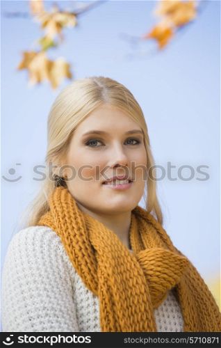 Portrait of beautiful woman smiling against sky