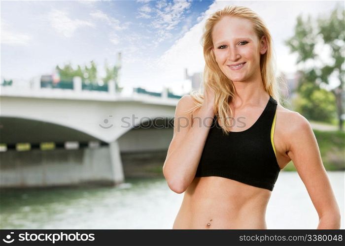 Portrait of beautiful woman smiling near bridge