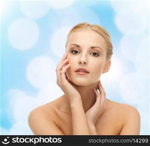 portrait of beautiful woman touching her face skin