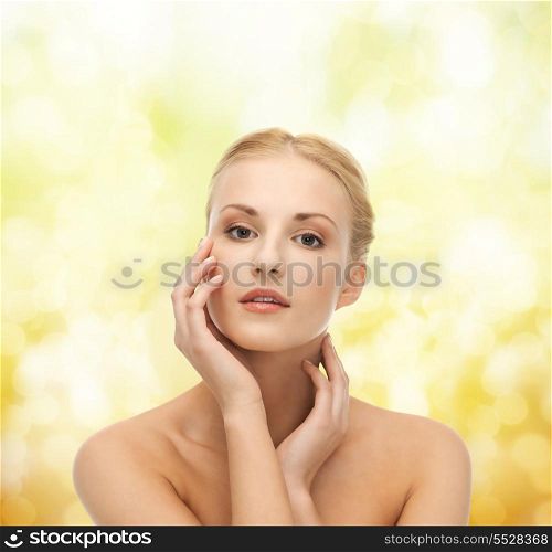 portrait of beautiful woman touching her face skin
