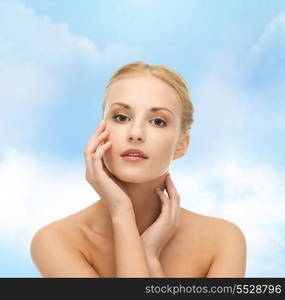 portrait of beautiful woman touching her face skin