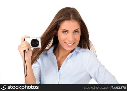 Portrait of beautiful woman using compact digital camera