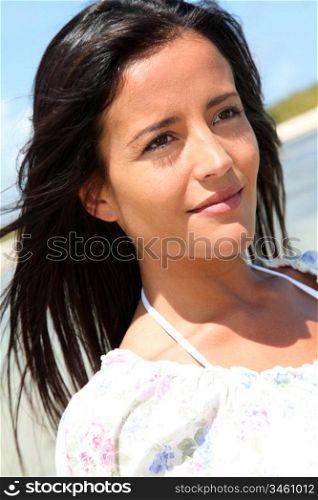 Portrait of beautiful woman walking by the beach