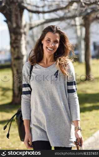 Portrait of beautiful woman wearing casual clothes in urban background