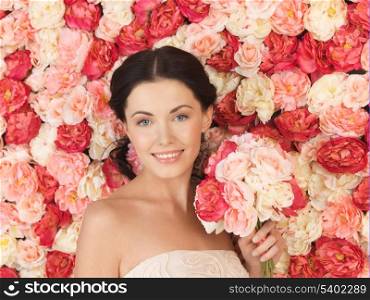 portrait of beautiful woman with background full of roses