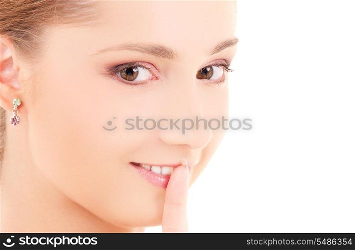 portrait of beautiful woman with finger on lips
