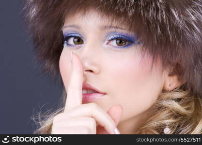 portrait of beautiful woman with finger on lips