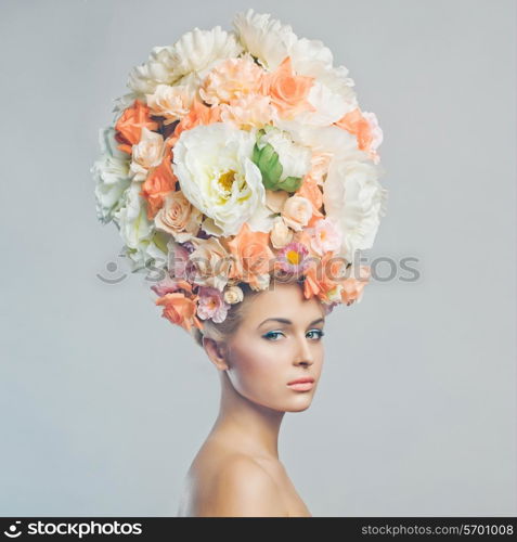 Portrait of beautiful woman with hairstyle of flowers. Fashion photo