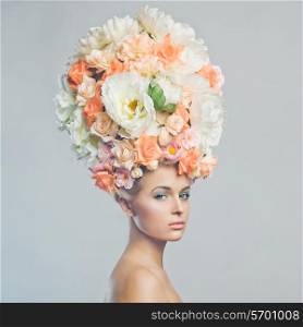 Portrait of beautiful woman with hairstyle of flowers. Fashion photo