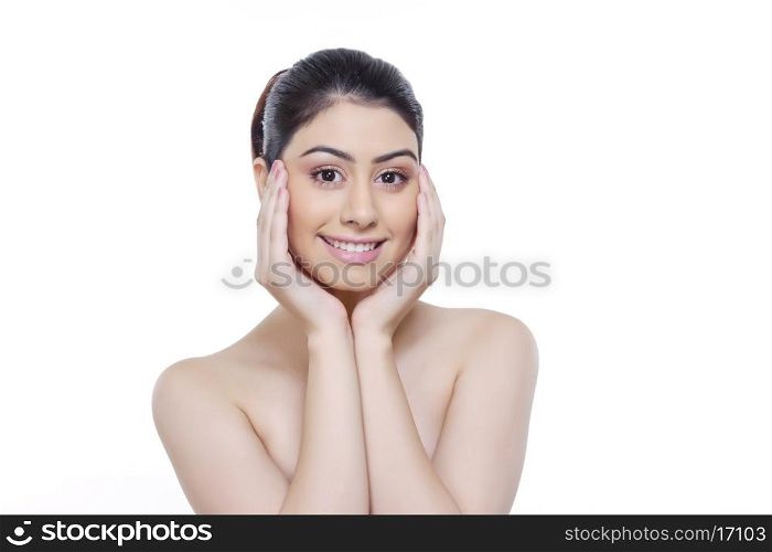 Portrait of beautiful woman with head in hands against white background