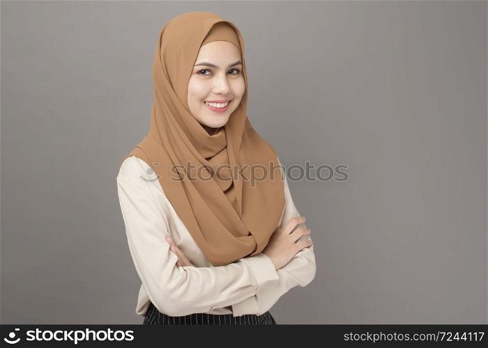 Portrait of beautiful woman with hijab is smiling on gray background