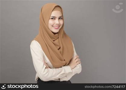Portrait of beautiful woman with hijab is smiling on gray background