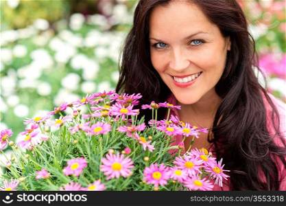 Portrait of beautiful woman with purple flowers in garden shop