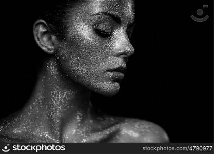 Portrait of beautiful woman with sparkles on her face. Girl with art make up in color light. Fashion model with colorful make-up. Black and White