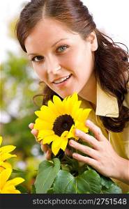 Portrait of beautiful woman with sunflowers on white background
