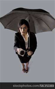Portrait of beautiful woman with umbrella asking comment