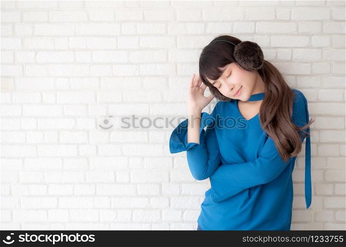 Portrait of beautiful young asian woman enjoy and happiness standing on gray cement texture grunge wall brick background, girl is a smiling and cheerful on concrete.