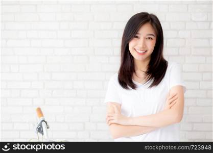 Portrait of beautiful young asian woman happiness standing on gray cement texture grunge wall brick background, businesswoman is a smiling on concrete, business people concept.