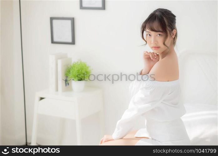 Portrait of beautiful young asian woman makeup of cosmetic, girl happy and smile attractive, face of beauty perfect with wellness in the bedroom at home with skin care and healthcare concept.