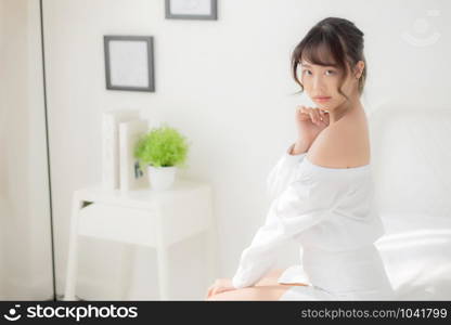 Portrait of beautiful young asian woman makeup of cosmetic, girl happy and smile attractive, face of beauty perfect with wellness in the bedroom at home with skin care and healthcare concept.