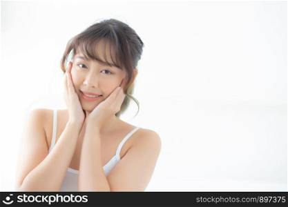 Portrait of beautiful young asian woman smile while wake up healthy and wellness with sunrise at morning in the bedroom, asia girl skin care with happy with fresh, lifestyle and relax concept.