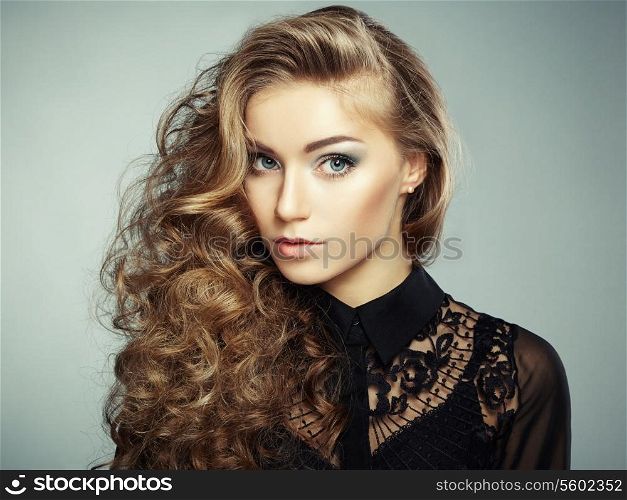 Portrait of beautiful young blonde girl in black dress