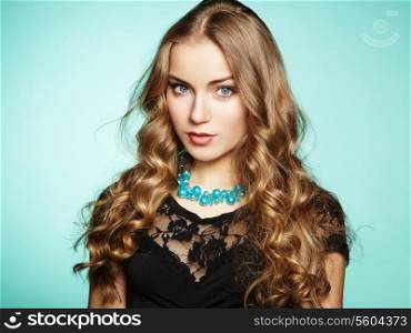 Portrait of beautiful young blonde girl in black dress. Fashion photo