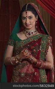 Portrait of beautiful young bride in traditional outfit
