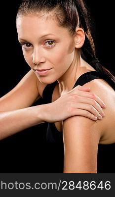 Portrait of beautiful young Caucasian woman doing stretching exercises pose