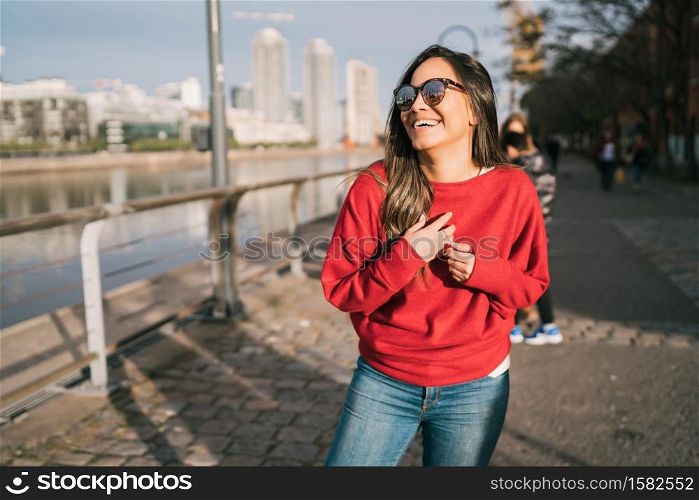 Portrait of beautiful young confident woman happy and excited outdoors in the street.