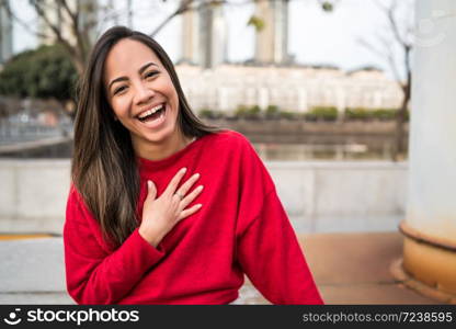 Portrait of beautiful young confident woman happy and excited outdoors in the street.