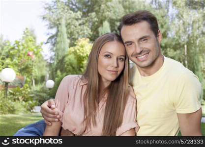 Portrait of beautiful young couple spending leisure time in park