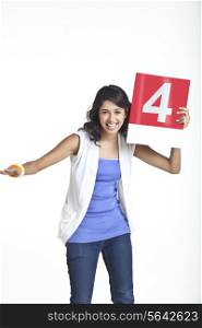 Portrait of beautiful young female signaling four over white background