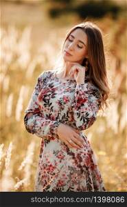 Portrait of beautiful young girl outdoors in spring. young girl in a field.. Portrait of beautiful young girl outdoors in spring. young girl in a field