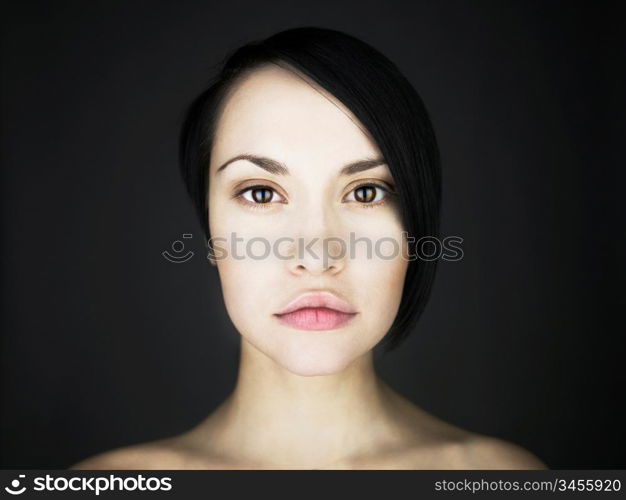 Portrait of beautiful young lady on a black background