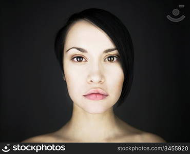 Portrait of beautiful young lady on a black background