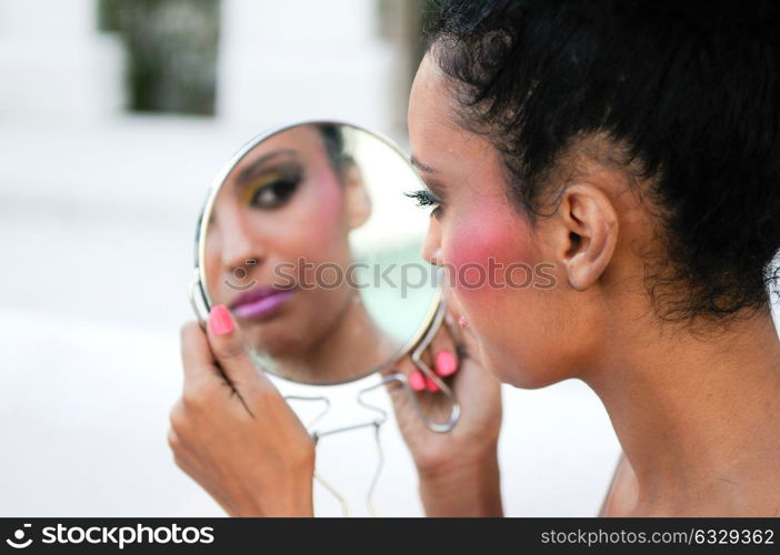 Portrait of beautiful young mixed woman eating an red apple, isolated on white