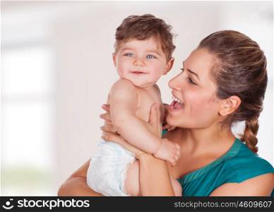 Portrait of beautiful young mother with cute adorable son having fun at home, with pleasure spending time, happy family life
