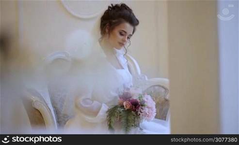 Portrait of beautiful young smiling bride with bouquet