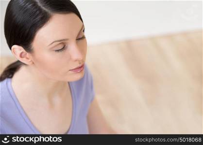Portrait of beautiful young woman doing yoga exercise - Meditating