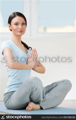 Portrait of beautiful young woman doing yoga exercise - Meditating