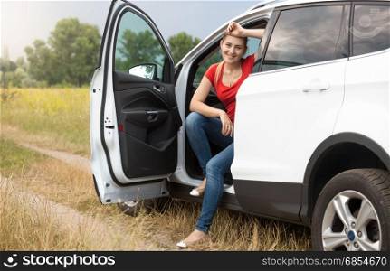 Portrait of beautiful young woman got lost while driving car