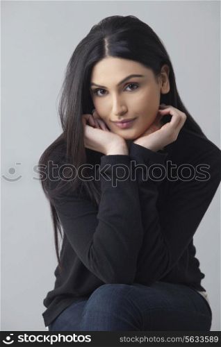Portrait of beautiful young woman in casual wear with long hair isolated over colored background