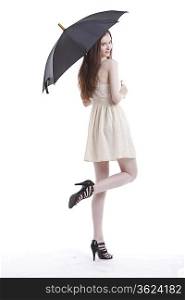 Portrait of beautiful young woman in dress with umbrella against white background