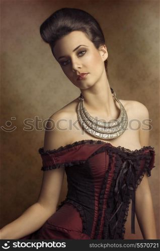 portrait of beautiful young woman in elegant old fashion purple dress , and a very importatnt necklace. hairdo.