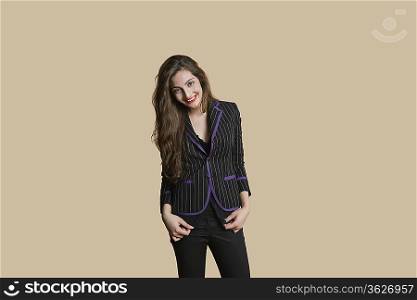 Portrait of beautiful young woman in formals over colored background