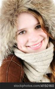 Portrait of beautiful young woman in fur hood of winter coat