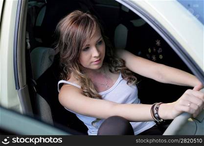Portrait of beautiful young woman in the new car - outdoors