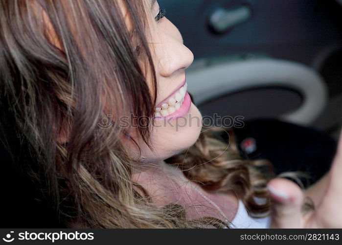 Portrait of beautiful young woman in the new car - outdoors