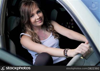 Portrait of beautiful young woman in the new car - outdoors